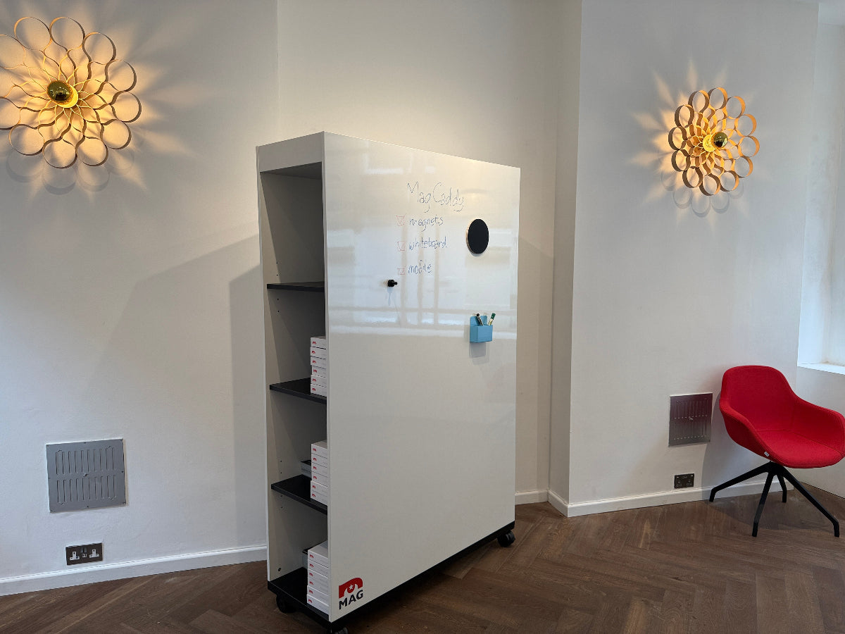 Modern interior with a white wall-mounted shelf, decorative lights, and a red logo.