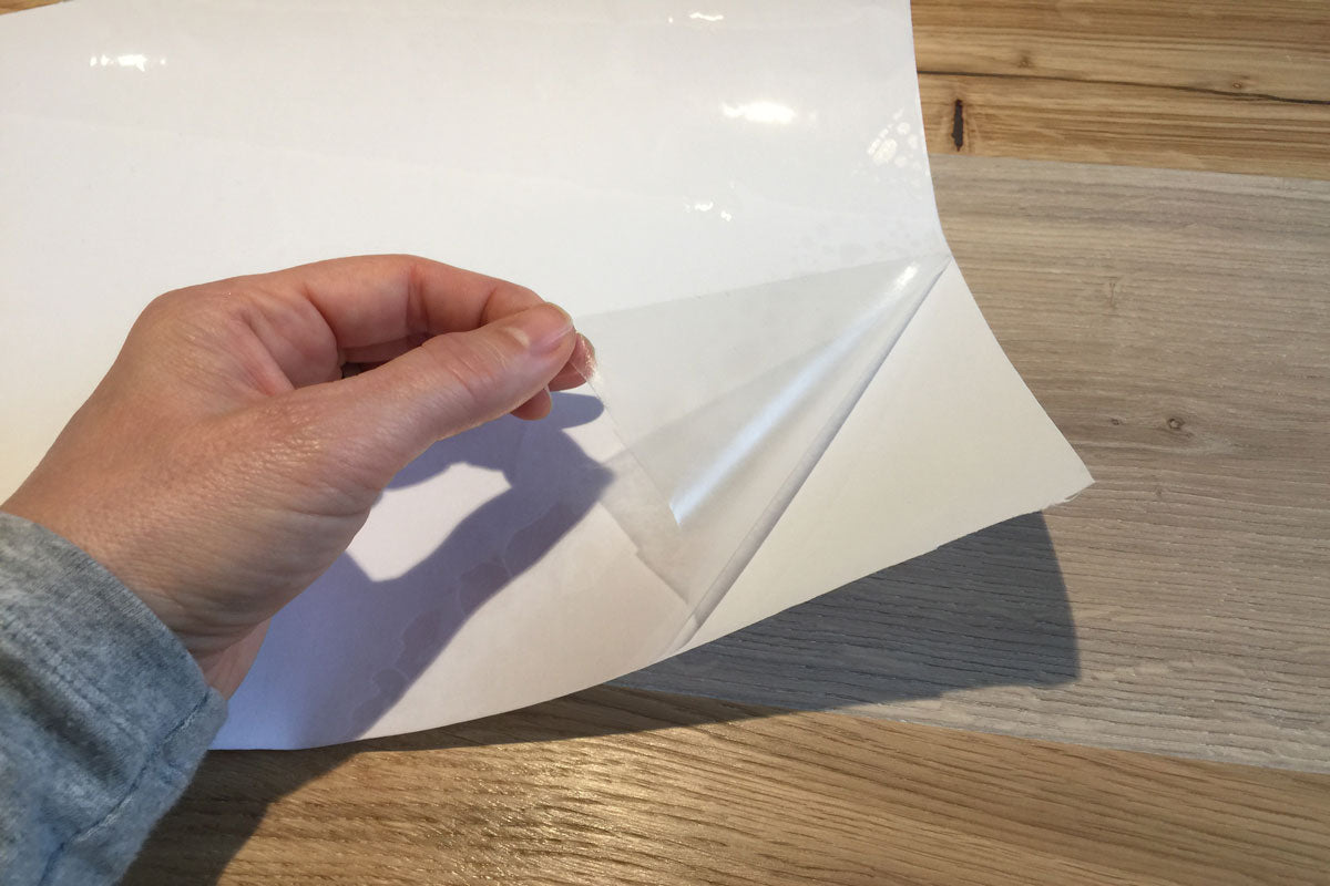 WriteFilm - Gloss Dry Erase Film pulling away from Backer