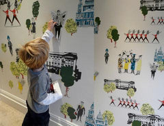Young boy uses magnets on wall